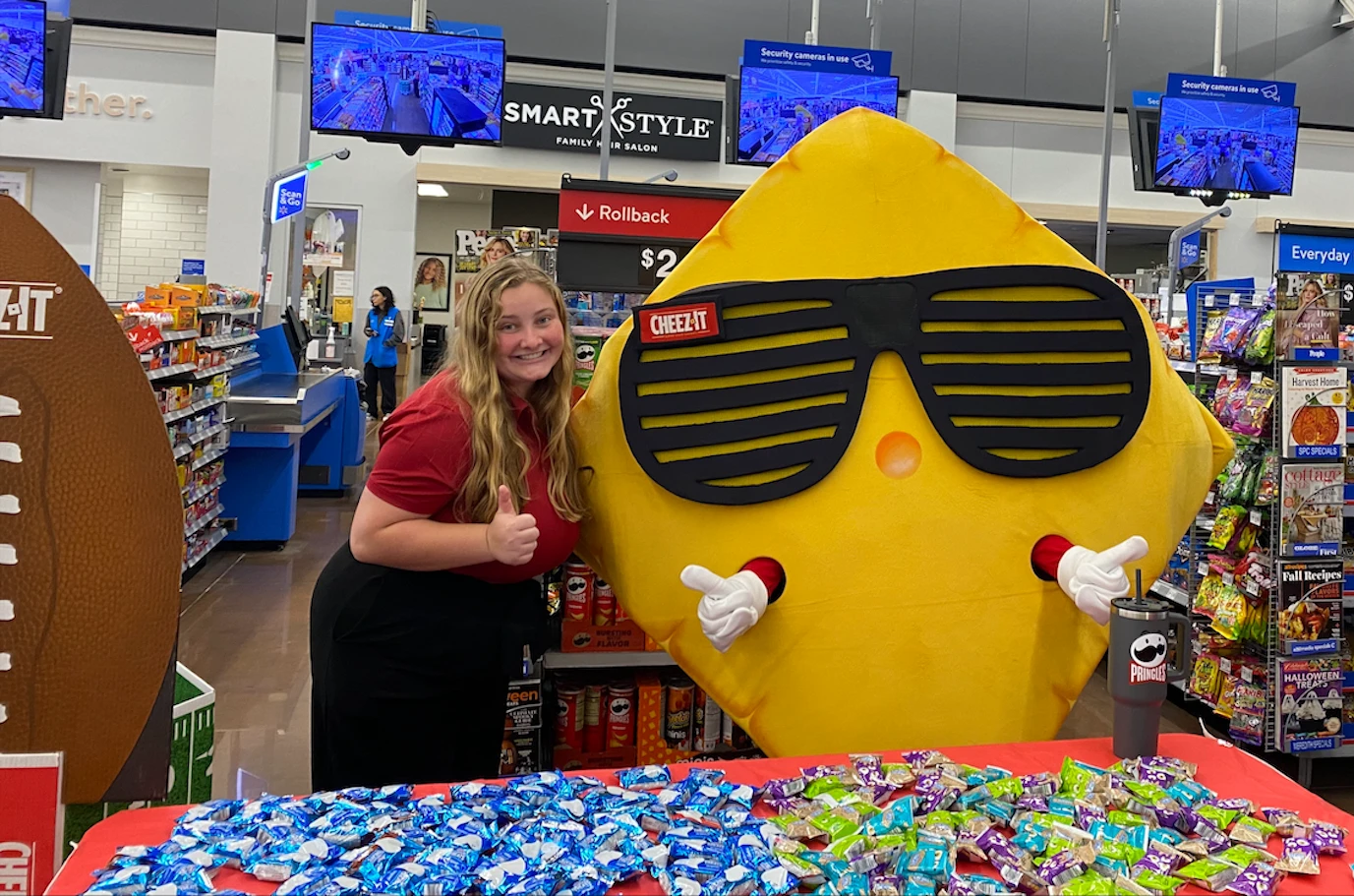 Kellanova Employee Madeline Kastel with Cheez-It Mascot and In-Store Display