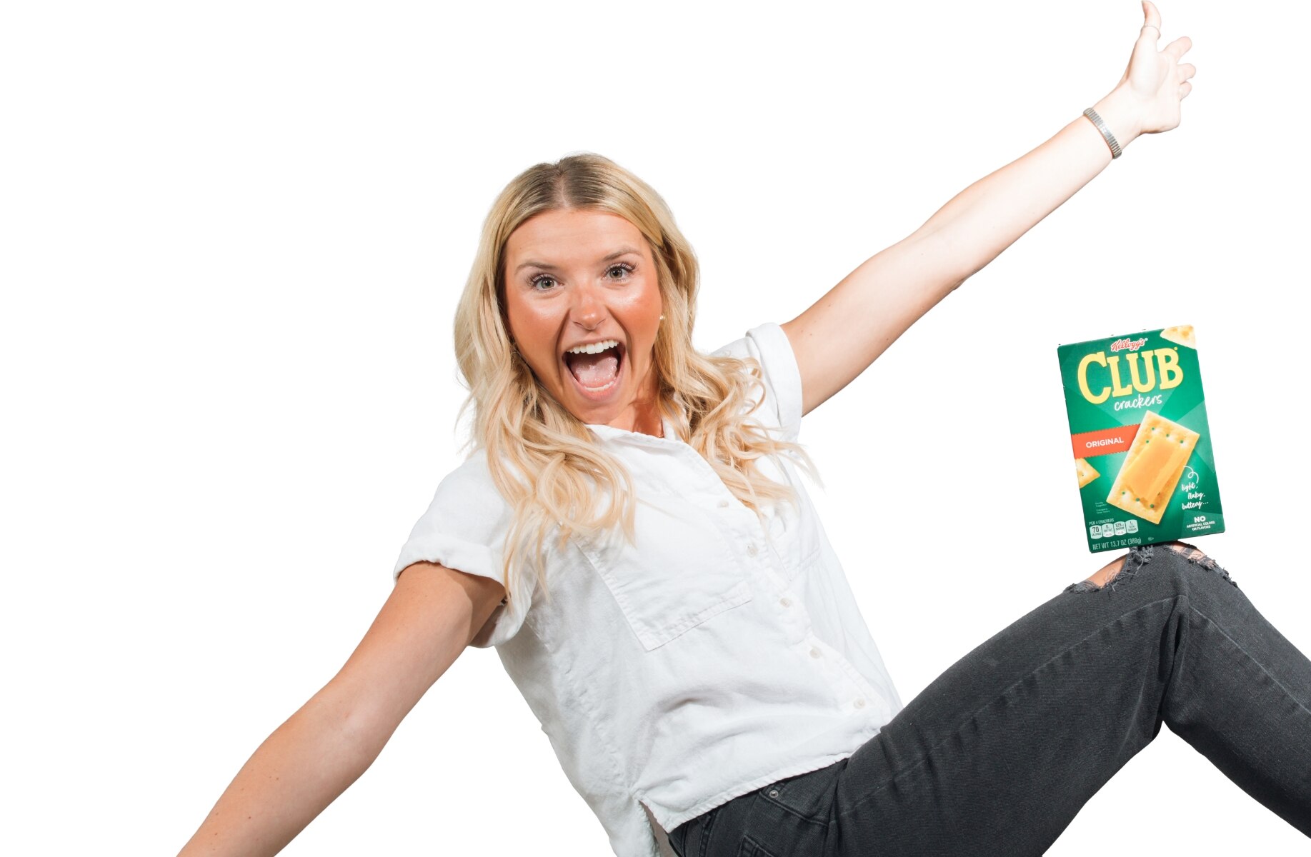 Kellanova employee balancing box of Club Crackers on her knee with arms outstretched